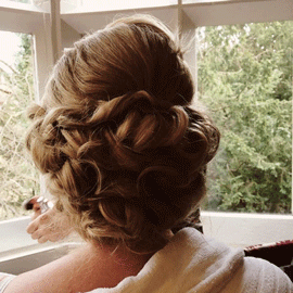 bridal hair up in dressing gown at hotel